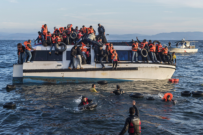 Syrian and Iraqi immigrants getting off a boat